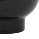 Tight crop on the lower body and pedestal base of a glossy charcoal ceramic planter, smooth finish visible