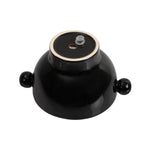 Underside of a glossy charcoal ceramic planter turned upside down, showing drain hole and rubber stopper hardware