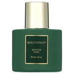 Green matte bottle of BEAUTYSPACE Winter Pine room spray with gold cap and label on white background