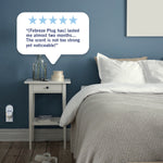 Bedroom scene with a Febreze Plug in a wall outlet and a speech bubble containing a five-star customer quote about scent strength.