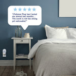 Staged bedroom scene with a Febreze plug-in on the wall and a five-star style customer quote callout above the nightstand.