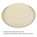 Underside view of a beige plastic plant saucer showing molded base detail and shallow rim on white background