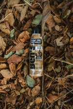 Camo-pattern Ben's scent free hunting formula aerosol can lying among dry autumn leaves in outdoor setting