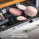 Blush bowl disassembled across the open rack of a dishwasher to illustrate that parts are dishwasher safe.