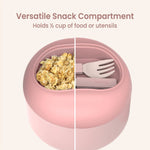 Close-up of blush bowl top showing versatile snack compartment half filled with granola and utensils in the other half.