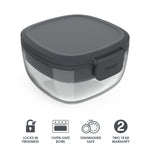 Closed dark gray Bentgo glass salad container showing clear glass bowl and snap-lock lid at an angle on white background