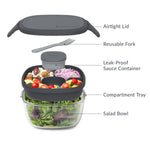 Exploded view of Bentgo salad container showing airtight lid, reusable fork, leak-proof sauce cup, compartment tray and glass bowl with labels
