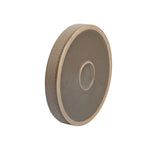 Side-profile of a round Better Homes & Gardens ceramic saucer with textured outer wall and recessed center ring on a gray-brown finish.