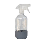 Clear reusable glass spray bottle with translucent trigger and gray rubber base