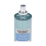 Close-up of the top half of a teal Better Homes & Gardens Oceanside Flannel spray bottle showing the silver spray nozzle and label