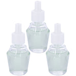 Three clear glass plug-in fragrance refill bottles with pale green oil and white caps against a white background.