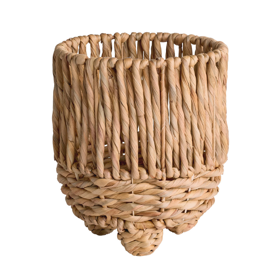 Close-up of a twisted water hyacinth round footed planter with braided feet