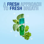 Stylized product image of Beyond Breath bottle with mint and parsley leaves on pale blue background