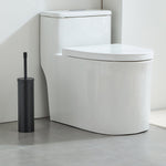 Matte black toilet brush and slim cylindrical holder placed next to a white modern toilet in a tiled bathroom