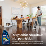 Family dining room scene with person using an upright BISSELL vacuum, dog on a bed and product bottle inset 'Designed for households with pets & kids'