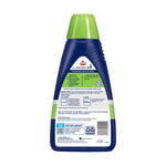 Rear label view of a BISSELL Pet Advanced Spot & Stain bottle showing usage instructions, warnings, and barcode on a white background.