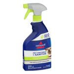 Side-angle view of a BISSELL Pet Pretreat + Sanitize blue spray bottle with green trigger and label details visible