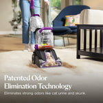 Person using upright carpet cleaner extracting dirt with copy about patented odor elimination technology