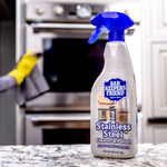 Lifestyle shot of a Bar Keepers Friend stainless steel cleaner bottle placed on a countertop with an oven in the background.