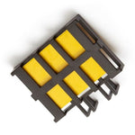 Close-up of a black plastic lure cartridge with six yellow octenol pads seen from above on white background