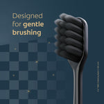 Black toothbrush head close-up on a dark checkered background with copy reading 'Designed for gentle brushing' and subtle star accents