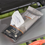 Opened Blackstone cleaning cloths pack with a white pre-moistened wipe partially pulled out on a grill shelf.