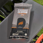 Blackstone cleaning cloths packet placed on a gray metal side shelf of a grill in outdoor setting.