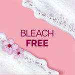 Pink background with white foam and cherry blossom accents around bold 'BLEACH FREE' text