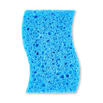 Close-up of the blue porous foam side of a curved cleaning sponge showing open-cell texture.