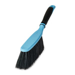 Blue handheld broom with black bristles and a soft-grip handle photographed on white background