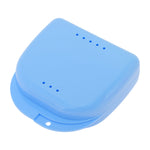 Closed small blue plastic orthodontic/retainer case with ventilation holes on top