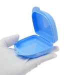 Open blue plastic orthodontic case shown in a gloved hand, ventilation holes visible