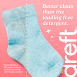 Blue sock with a vertical dashed line showing a dramatized dirty-to-clean split and text claiming better clean on pink background