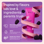 Boka Kids Bubble Gum toothpaste tube wrapped by a ribbon with blackberries and feature text calling out ingredients parents trust on purple background.