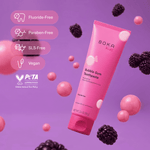 Floating Boka Kids Bubble Gum toothpaste tube surrounded by pink spheres and blackberries with badges listing fluoride-free, paraben-free, SLS-free and vegan.