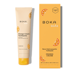Boka Kids Orange Cream toothpaste tube beside its matching orange box, packaging shows brand name and citrus graphics.