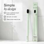 Two mint green Boka toothbrushes displayed upright on a tiled surface with one in its mint green box and design feature text.