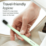 Hand placing a mint BOKA toothbrush with a clear snap-on travel cap into a bag, travel-friendly text overlay