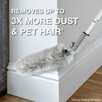 Gray Bona microfiber duster attached to a pole cleaning the corner of a baseboard with large text claiming it removes up to 3X more dust and pet hair.