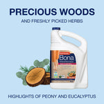 Large Bona refill jug with cedar wood illustration against a pale blue background and “PRECIOUS WOODS” headline
