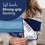 Close-up of a hand peeling back Bona microfiber pad showing branded backing and strong-grip attachment