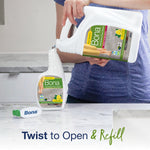 Person pouring Bona refill jug into a smaller Bona spray bottle on a countertop, showing twist-to-open refill action