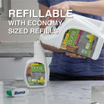 Person pouring a large Bona refill jug into a spray bottle with text ‘Refillable with economy sized refills’