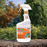 Bonide Captain Jack's Copper Fungicide spray bottle placed outdoors among garden plants on stone ledge