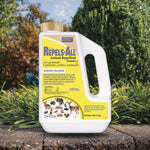Bonide Repels-All granules jug displayed outdoors on a stone surface with shrubs in the background