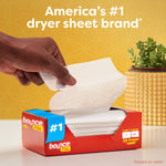 Open red box dispensing a single white Bounce dryer sheet with hand pulling a sheet and #1 branding