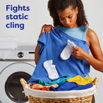 Woman inspecting a blue shirt from a laundry basket with socks clinging, alongside text about fighting static cling