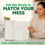 Smiling person pulling a full-size sheet from a paper towel roll on a countertop with text about matching your mess