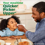 Father wiping a smiling child’s face with a Bounty Napkin at a kitchen table with product messaging text