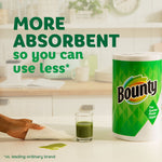 Single Bounty paper towel roll on a counter beside a small green drink and a hand wiping a spill, absorbent claim text